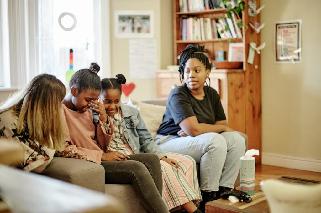 Family, therapy and mother with crying children in counseling session, consulting and help for pare